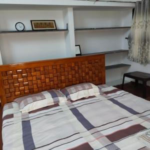 a bedroom with a bed and a clock on the wall at Natural bliss in Tiruchirappalli