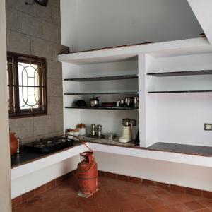 a kitchen with a fire hydrant in a room at Natural bliss in Tiruchirappalli
