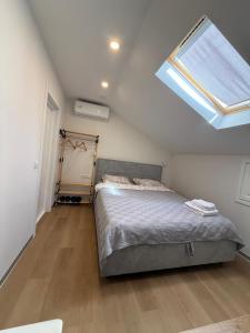 a bedroom with a bed and a skylight at Bazar Motel in Chişinău