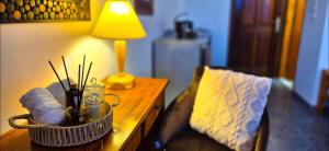 a living room with a table with a lamp on a couch at Knossos Skynest in Palekastron