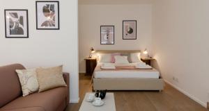 a small bedroom with a bed and a couch at Modern Apartment between Como & Milan in Lomazzo