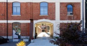 a large brick building with a large doorway at Modern Apartment between Como & Milan in Lomazzo