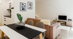 a living room with a couch and a table at Modern Apartment between Como & Milan in Lomazzo