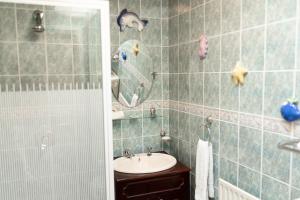a bathroom with a sink and a shower with a mirror at The Wild Atlantic Hideaway in Inch +34 photos
