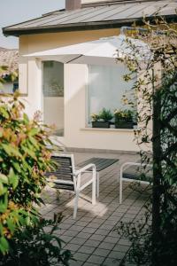 a white bench sitting on a patio in front of a house at Domus Silvana Apartments in Ravenna +36 photos