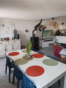 a kitchen with a table and chairs in a room at Chez Mimi et Mimine in Lons-le-Saunier