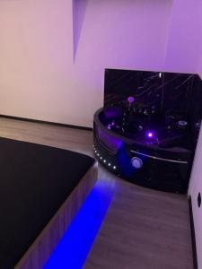 a room with a black bathtub with blue lights at Sanu Home B&B in Lonate Pozzolo