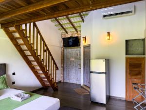 a room with a refrigerator and a staircase at Leisure Land in Galle