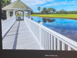 a gazebo on a bridge over a river at First Class Treatment Luxurious end unit Patio Pool Restaurant Bar on premises Steps away from Everything else! Spacious Condo Stocked with all You Need! in Myrtle Beach