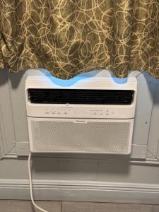 a toaster oven with a curtain on top of it at Park Motel in Tampa +8 photos