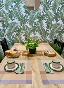 a table with two cups and plates on top at Castro Romano VUT 7712 AS in Gijón