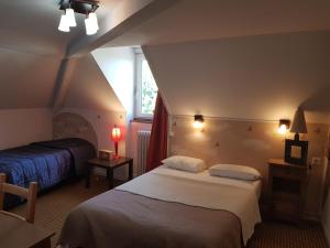 a hotel room with two beds and a window at Logis Hôtel Restaurant Les Capucins in Avallon +64 photos