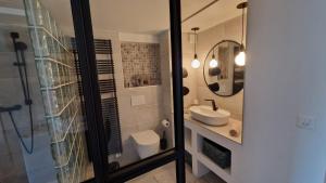a bathroom with a sink and a mirror at Au Bourg in Le Landeron +17 photos