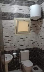 a bathroom with a toilet and a sink at الغردقة - اول ممشى شيرى in Hurghada