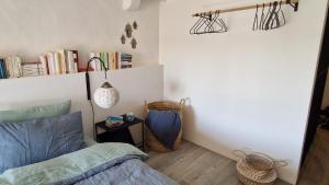a bedroom with a bed and a shelf with books at Au Bourg in Le Landeron