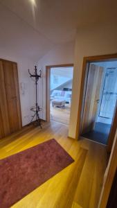 a living room with a large glass door and a rug at Ferienwohnung am Bühl in Cham