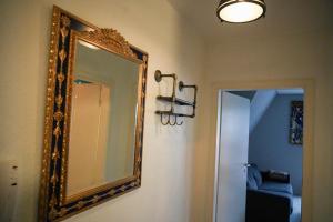 a mirror hanging on a wall next to a hallway at Ostsee43 - Apartment Ole in Rostock +21 photos