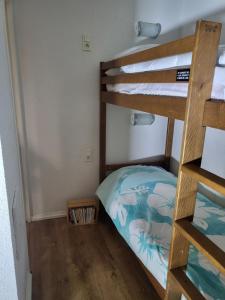 a bedroom with a bunk bed and a ladder at Douce Altitudes Cauterets in Cauterets +16 photos