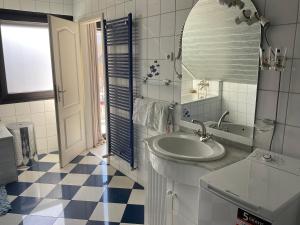 a white bathroom with a sink and a mirror at Emma in Oberhausen