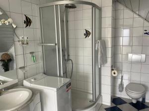 a bathroom with a shower and a toilet and a sink at Emma in Oberhausen