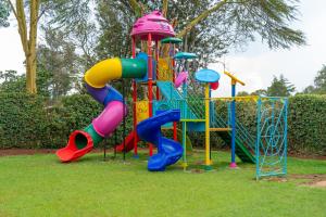 a playground with a colorful slide and a play structure at Nyeri Club in Nyeri