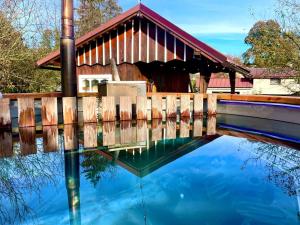 a covered bridge with a reflection in the water at Roprachtická chalupa in Roprachtice