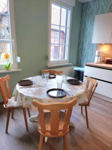 a dining room table with a table cloth on it at Ferienwohnung am Drömling Südheide - Gerda in Bergfeld