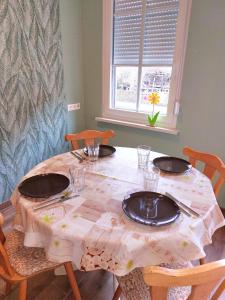 a table with a table cloth on it with plates and chairs at Ferienwohnung am Drömling Südheide - Gerda in Bergfeld +36 photos