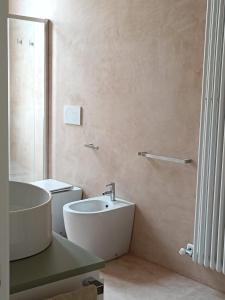 a bathroom with a sink and a toilet at Dimora Novecento Lecce in Lecce +23 photos