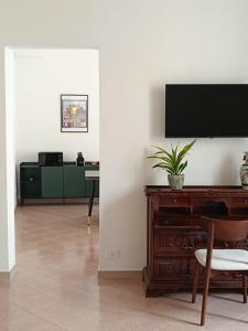 a living room with a flat screen tv on a wall at Dimora Novecento Lecce in Lecce