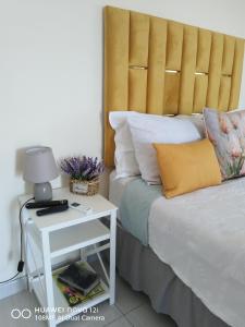 a bedroom with a bed and a nightstand with a lamp at Springbok Guest house in Mandini