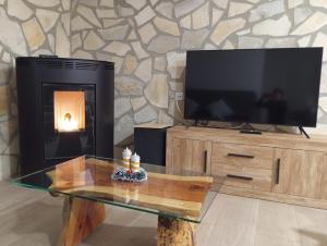 a living room with a tv and a fireplace at La Casita in Tejadillos