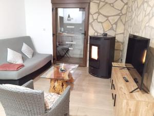 a living room with a couch and a fireplace at La Casita in Tejadillos