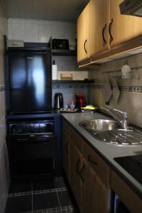 a small kitchen with a sink and a microwave at Studio Avondzon in Blankenberge +15 photos