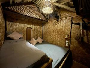 a bedroom with a bed in a room at 74YOU Beach Resort and Restaurant in Puerto Princesa City