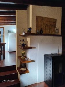 a living room with a fireplace and a tv at Casa Portela in Marialva