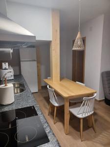a kitchen with a wooden table and chairs at La Casita in Tejadillos +17 photos
