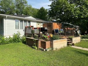a backyard with several wooden planters in the grass at The Hideout in Moorhead