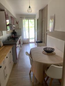 a kitchen with a table with a bowl on it at Les Cocons de Nabeillou in Graulhet