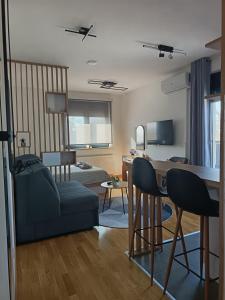 a living room with a couch and a table and chairs at Orca Apartman in Jagodina