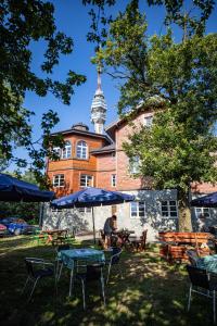 a man sitting at a table in front of a building at Avala apartments in Beli Potok