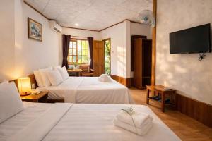 a hotel room with two beds and a flat screen tv at FORTUNE HOTEL 2 LUCKY STAY Phu Quoc in Phú Quốc +48 photos