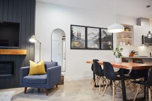 a dining room with a blue chair and a table at Ripper Retreat in Revelstoke