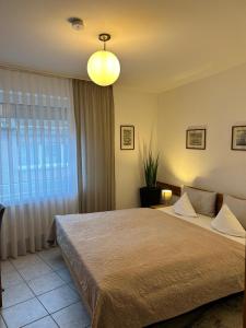 a bedroom with a large bed and a large window at Hotel zum Schiffchen in Brüggen