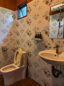 a bathroom with a toilet and a sink at Bungalow Scent in Da Lat +7 photos