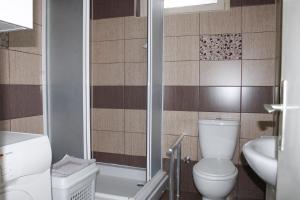 a bathroom with a toilet and a sink at Corner Five in Negotino +18 photos