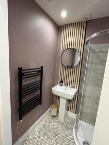 a bathroom with a sink and a mirror at The Doonleigh suite in Ayr