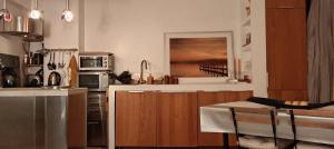 a kitchen with wooden cabinets and a counter top at Magnifique Loft 65m en Open Space in Paris +20 photos