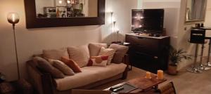 a living room with a couch and a table at Magnifique Loft 65m en Open Space in Paris