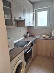 a kitchen with a sink and a stove top oven at Nelly Apartman in Gheorgheni